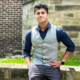 Arjun Nair sat on a wall outside the Management School.