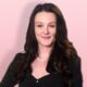 Student Chloe Coleridge in front of a pink background.