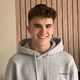 Student Jake Munro-Proud stood in front of a panelled wall