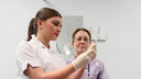 A female nursing student holding a syringe