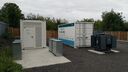 two large scale batteries in a yard