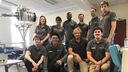 A group photo of the team with the reviewer