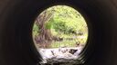 Inside of a water pipe, water cascading into a river