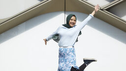 Student jumping outside the Diamond Building 