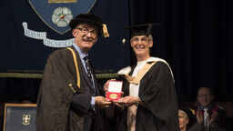 Sarah Evans receiving her Distinguished Alumni Award from Professor Mike Hounslow