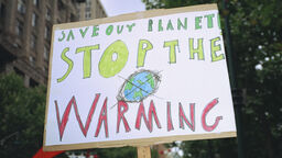 A protest sign 'Save our planet. Stop the warming'