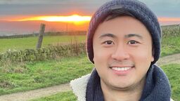 Sebastian Li looking happy in the countryside at sunset