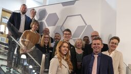 The advisory board stood together on a set of stairs.