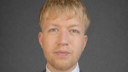 Student Brogan Horniman in a suit