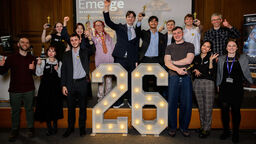 Group of students cheering on stage celebrating Emerge Awards Showcase 26