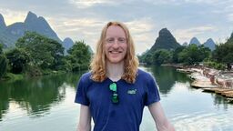 Our student Sam in China by some mountains.